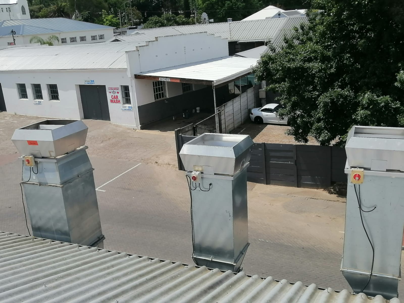 Bank of roof-mounted extraction stacks — workshop ventilation