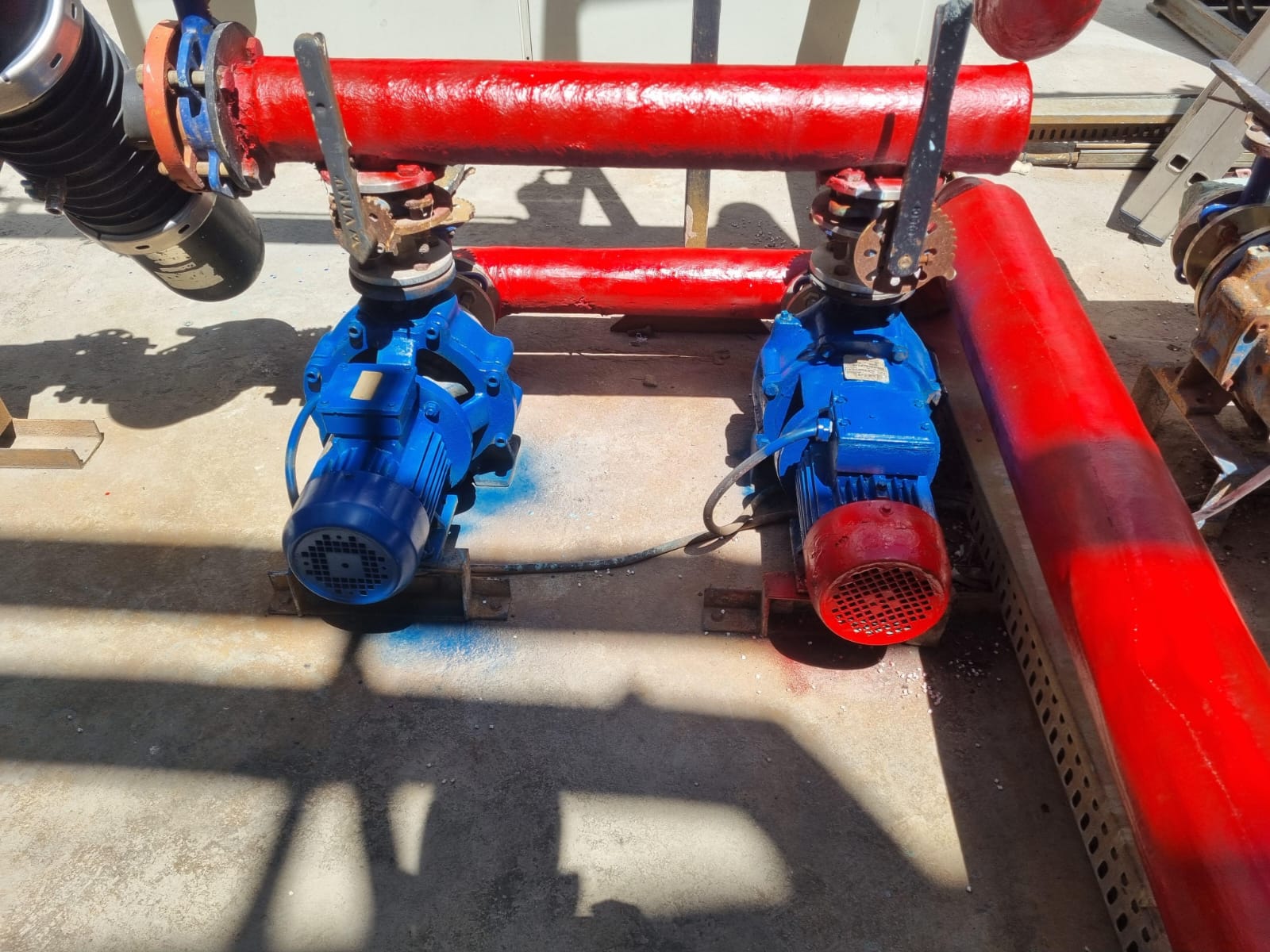 Twin glycol circulation pumps — insulated red flow & return headers